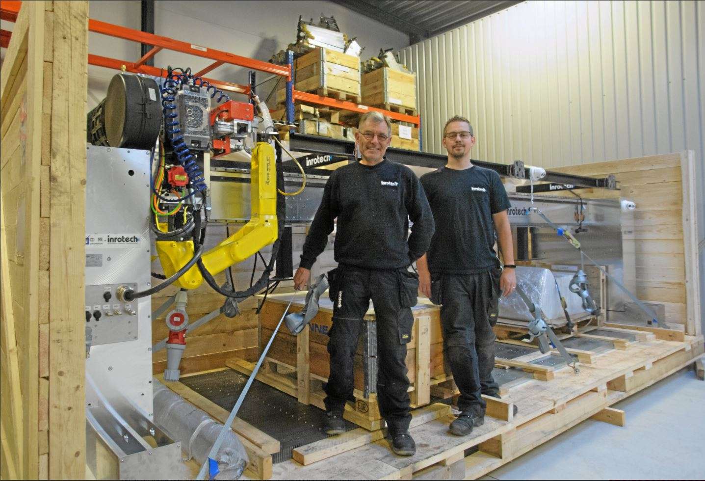 welders in front of welding robot